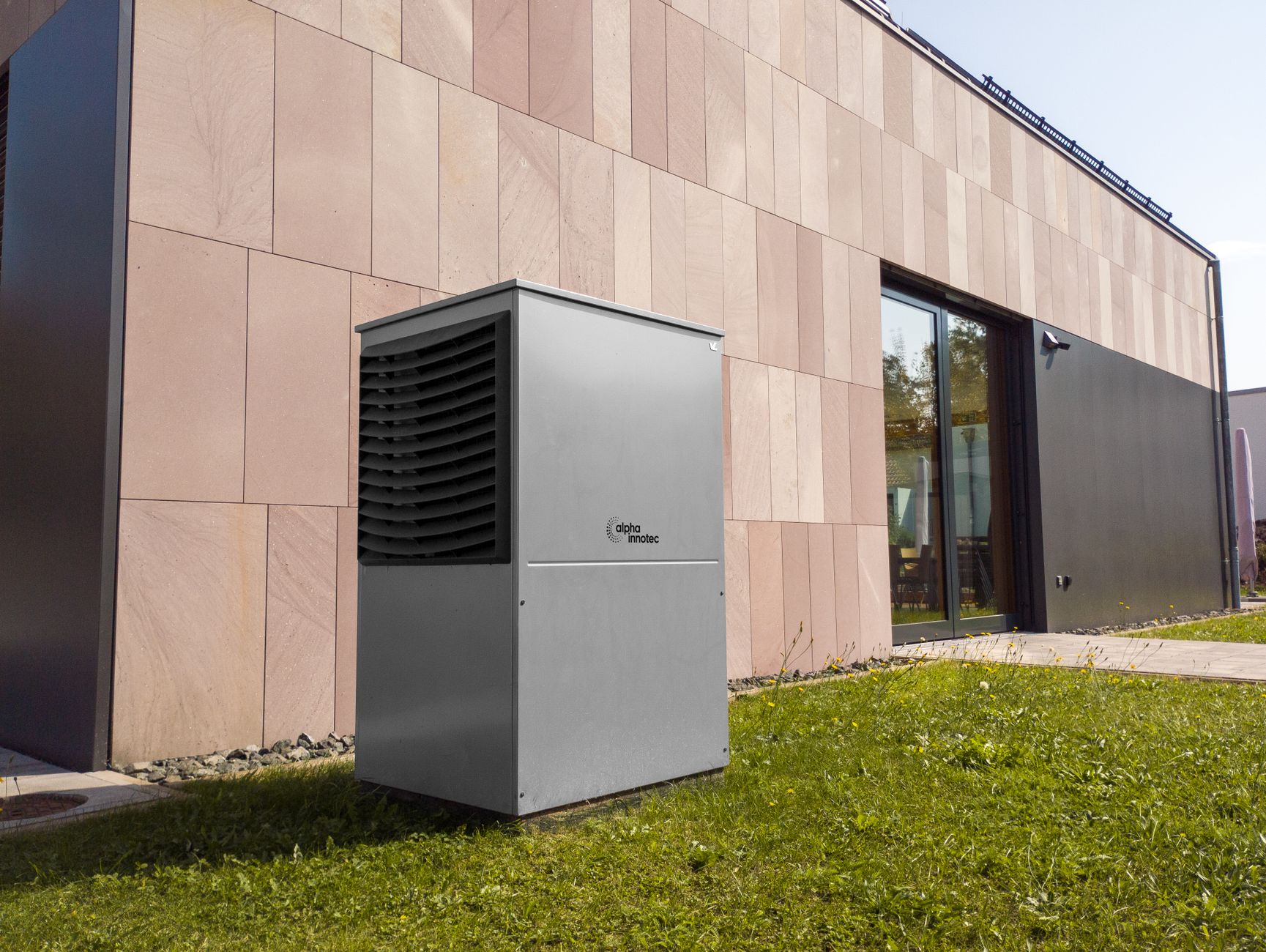 A heat pump outdoor unit installed beside a modern house
